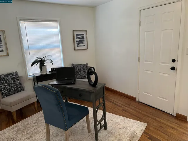 a work room with furniture and wooden floor