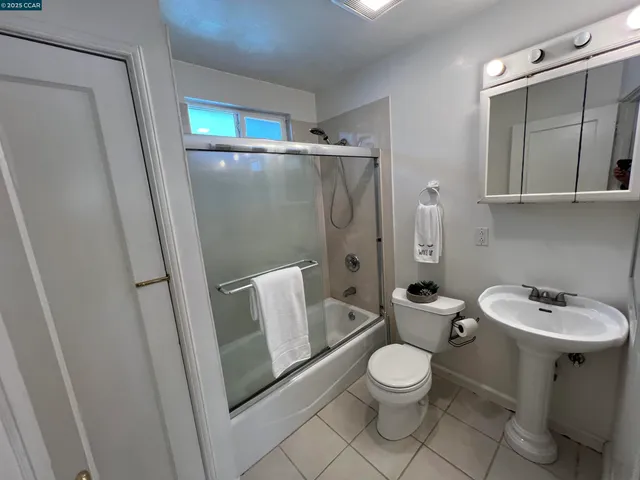 a bathroom with a toilet a sink and a mirror