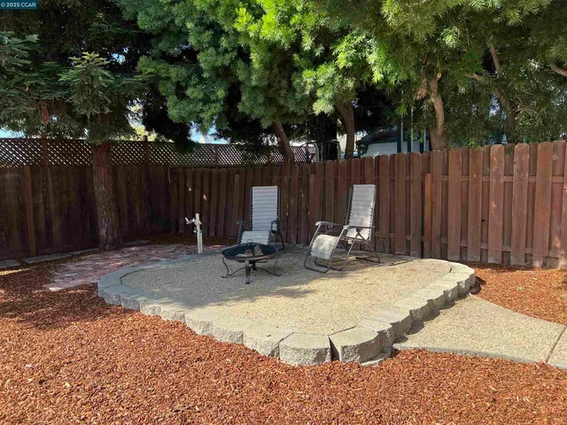 a view of a backyard with wooden fence