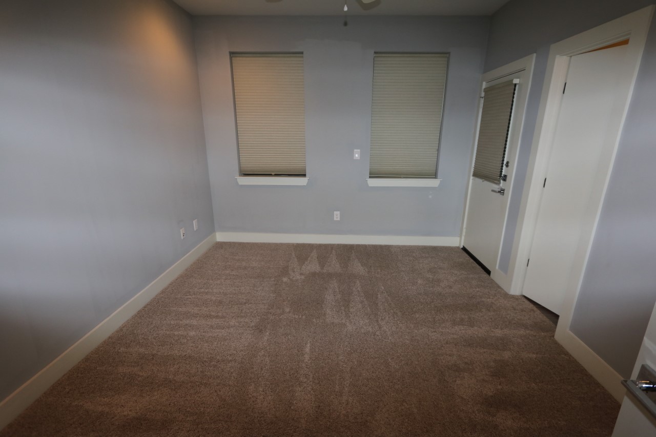 2103 Hadley Street Houston, TX 77003 - Photo 2 of 19 an empty room with wooden door and mirror