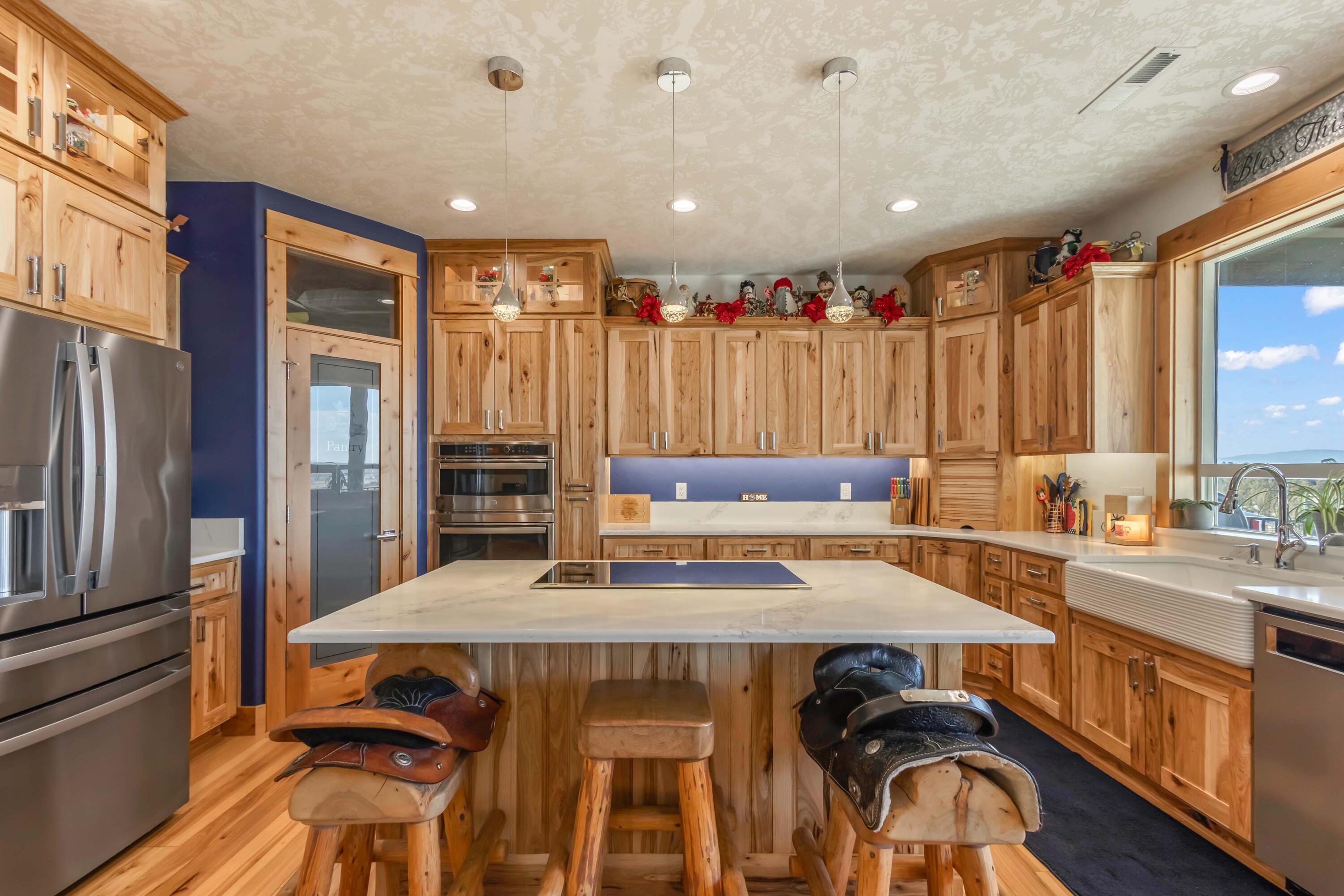 5582 North Mckay Road Prineville, OR 97754 - Photo 12 of 54 a kitchen with a sink a stove and chairs