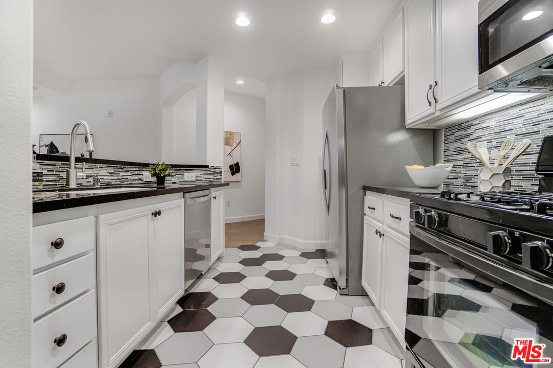 12963 West Runway Road, Unit 121 Playa Vista, CA 90094 - Photo 12 of 46 a kitchen with stainless steel appliances a stove a sink and a refrigerator