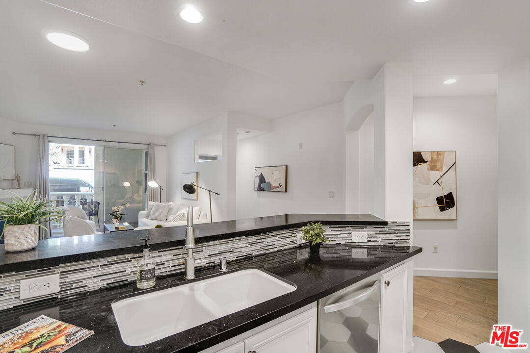 12963 West Runway Road, Unit 121 Playa Vista, CA 90094 - Photo 13 of 46 a kitchen with a sink and a stove top oven with wooden floor
