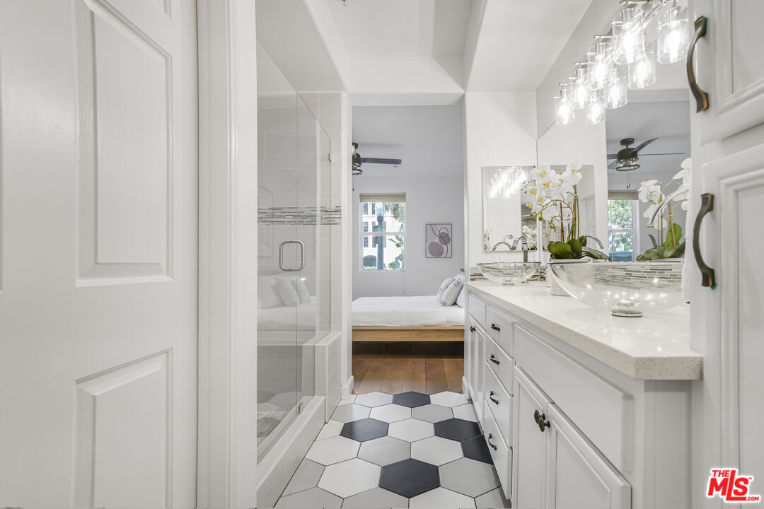 12963 West Runway Road, Unit 121 Playa Vista, CA 90094 - Photo 18 of 46 a spacious bathroom with a shower sink and mirror