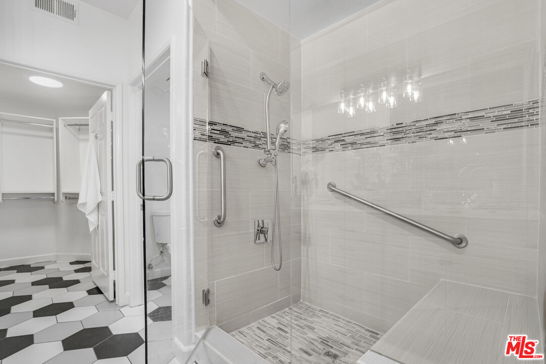 12963 West Runway Road, Unit 121 Playa Vista, CA 90094 - Photo 19 of 46 a bathroom with a glass shower door