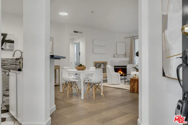 a view of kitchen and dining area with racks on the wall