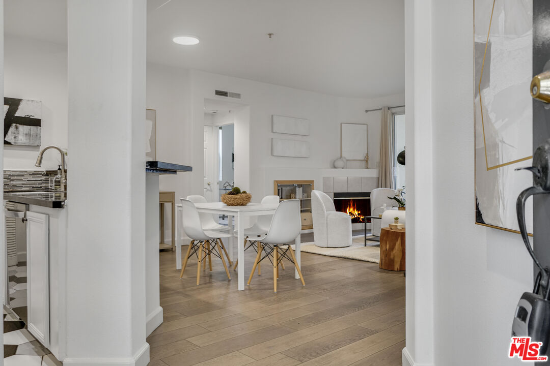 12963 West Runway Road, Unit 121 Playa Vista, CA 90094 - Photo 3 of 46 a view of kitchen and dining area with racks on the wall