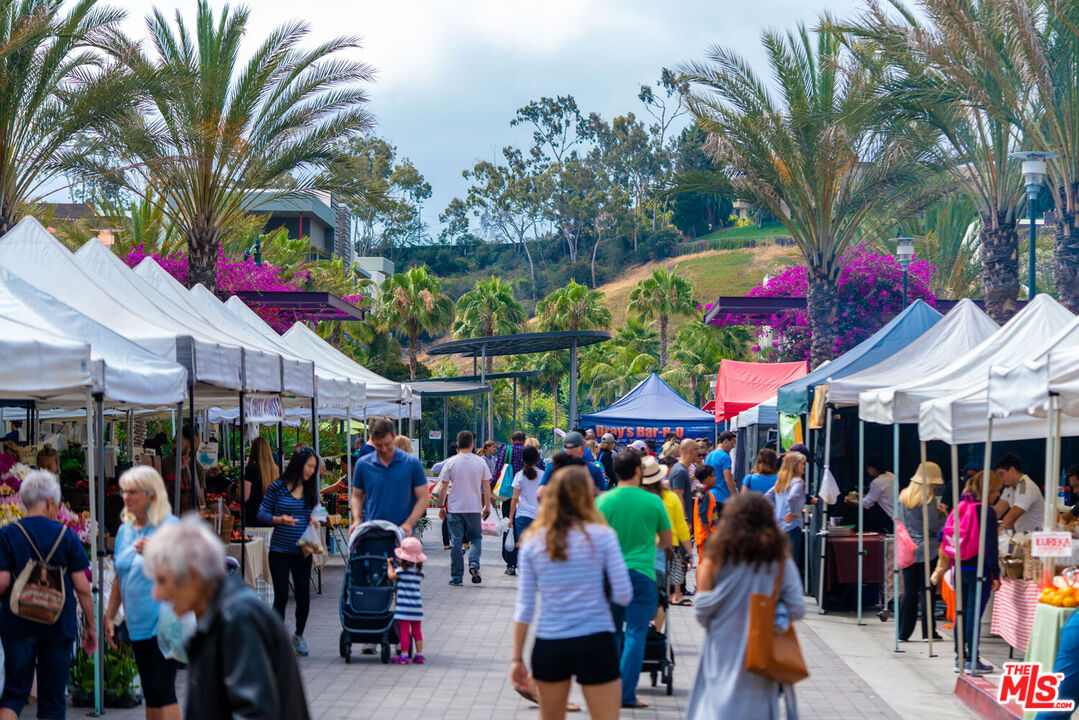 12963 West Runway Road, Unit 121 Playa Vista, CA 90094 - Photo 38 of 46 a group of people standing around a fruit stand