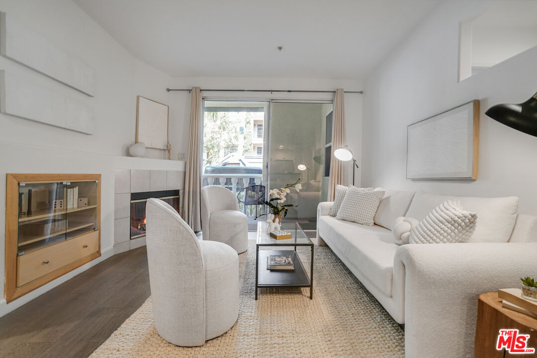 12963 West Runway Road, Unit 121 Playa Vista, CA 90094 - Photo 4 of 46 a living room with furniture a fireplace and a large window