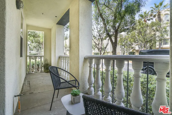 a view of a balcony with chairs