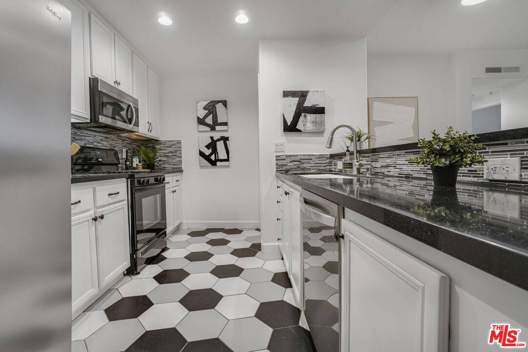 12963 West Runway Road, Unit 121 Playa Vista, CA 90094 - Photo 10 of 46 a kitchen with stainless steel appliances kitchen island granite countertop a sink and cabinets
