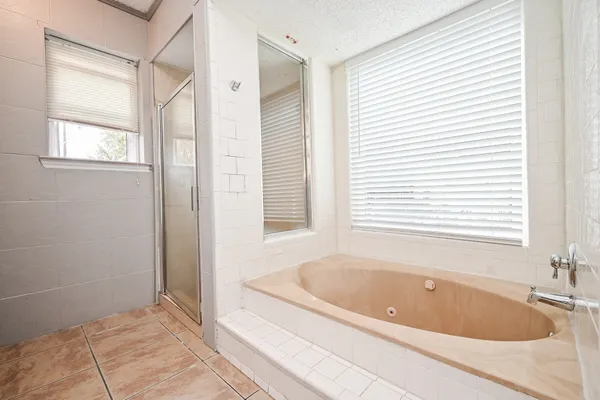 a bathroom with a bathtub and window