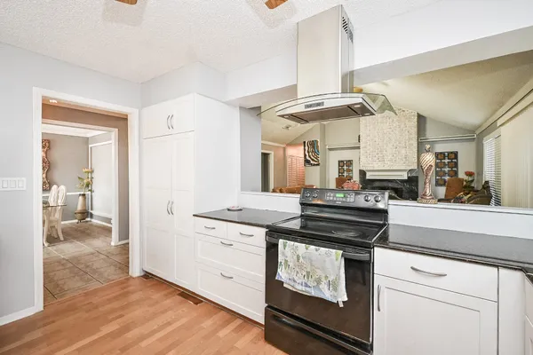 a kitchen with stainless steel appliances granite countertop a stove and a sink