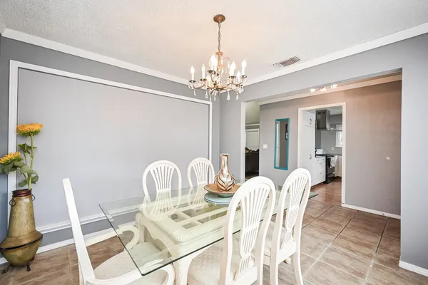 a dining room with furniture and chandelier