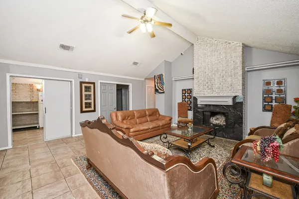 a living room with furniture and a fireplace