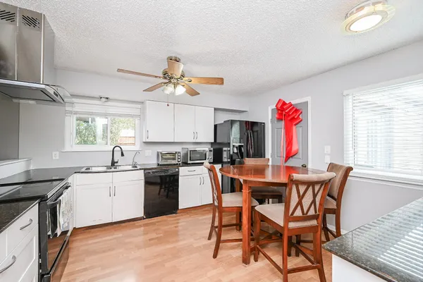 a view of a dining room with furniture and a kitchen