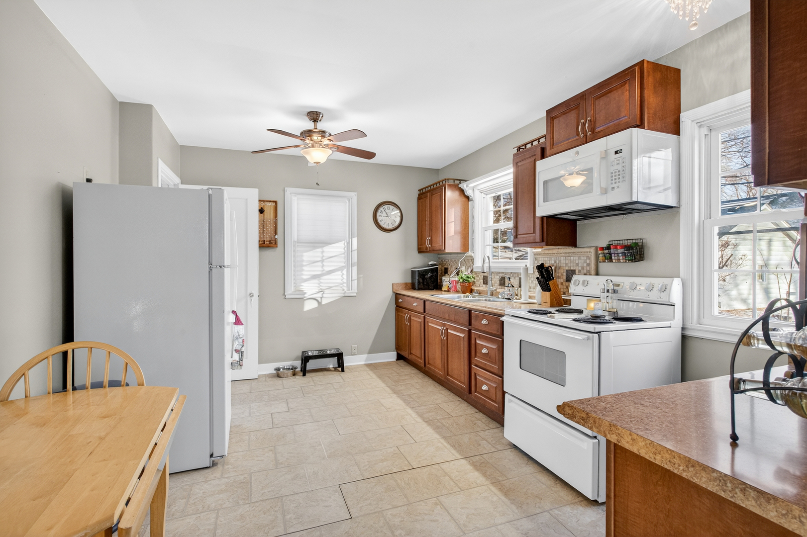 1336 Florence Avenue Clinton, IA 52732 - Photo 10 of 17 a kitchen with stainless steel appliances granite countertop a sink stove and refrigerator