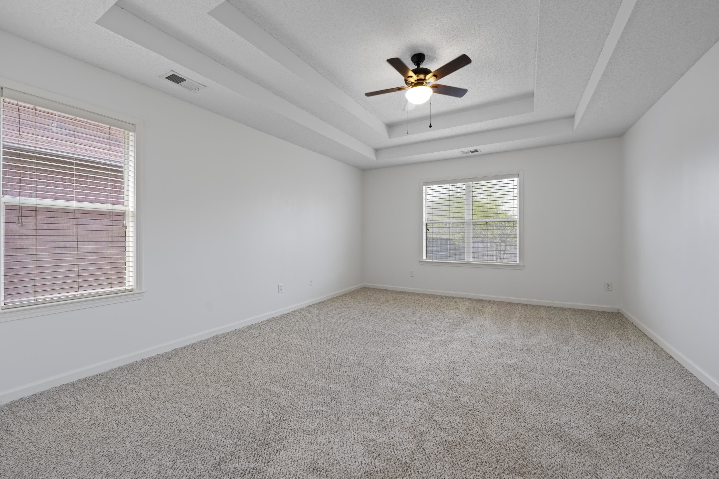1104 Macon Hall Road Cordova, TN 38018 - Photo 13 of 34 Spare room featuring light carpet, visible vents, a ceiling fan, and a raised ceiling