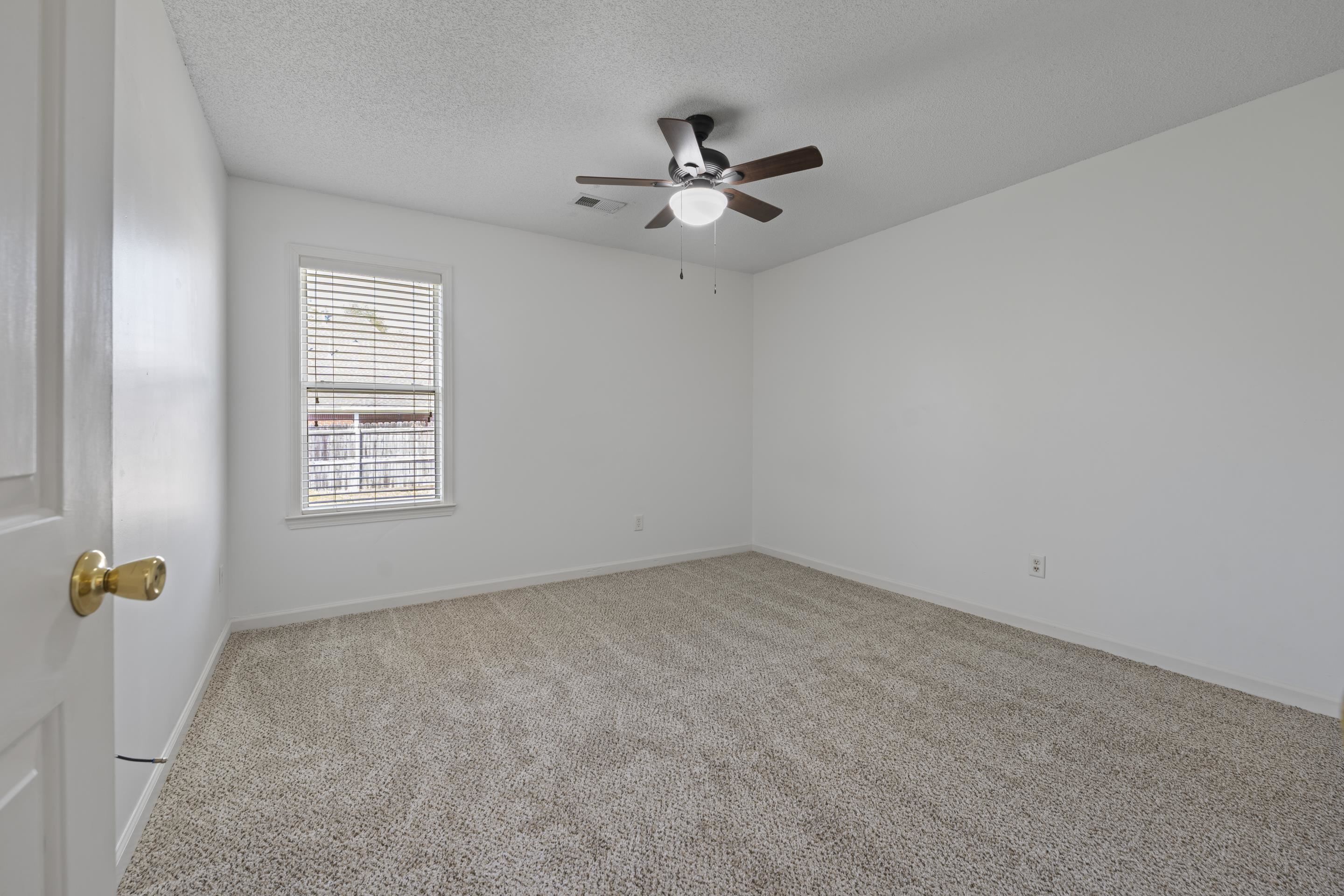 1104 Macon Hall Road Cordova, TN 38018 - Photo 21 of 34 Carpeted empty room with visible vents, ceiling fan, baseboards, and a textured ceiling