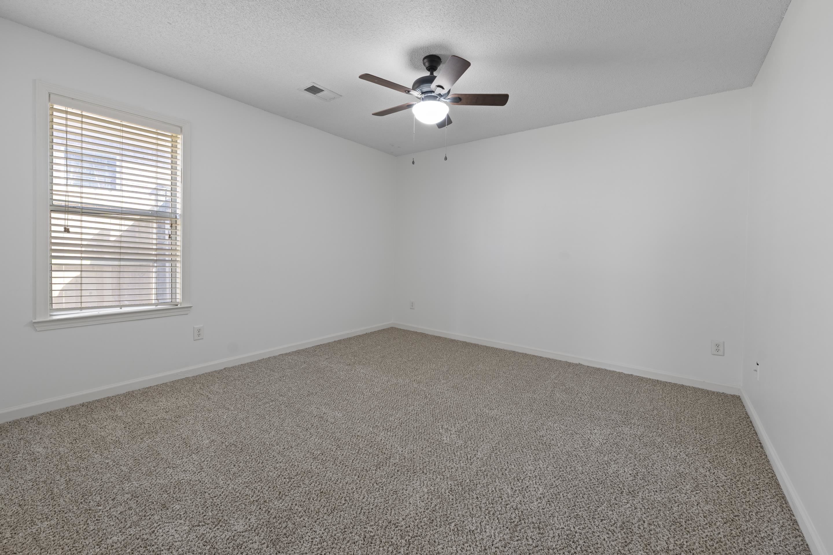 1104 Macon Hall Road Cordova, TN 38018 - Photo 24 of 34 Carpeted spare room with visible vents, baseboards, a ceiling fan, and a textured ceiling