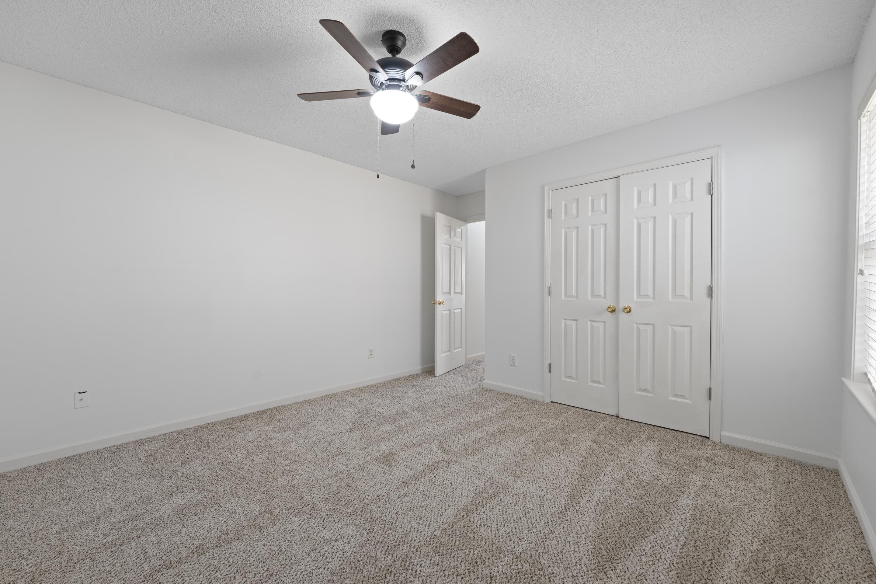 1104 Macon Hall Road Cordova, TN 38018 - Photo 25 of 34 Unfurnished bedroom featuring a closet, baseboards, a ceiling fan, and carpet floors