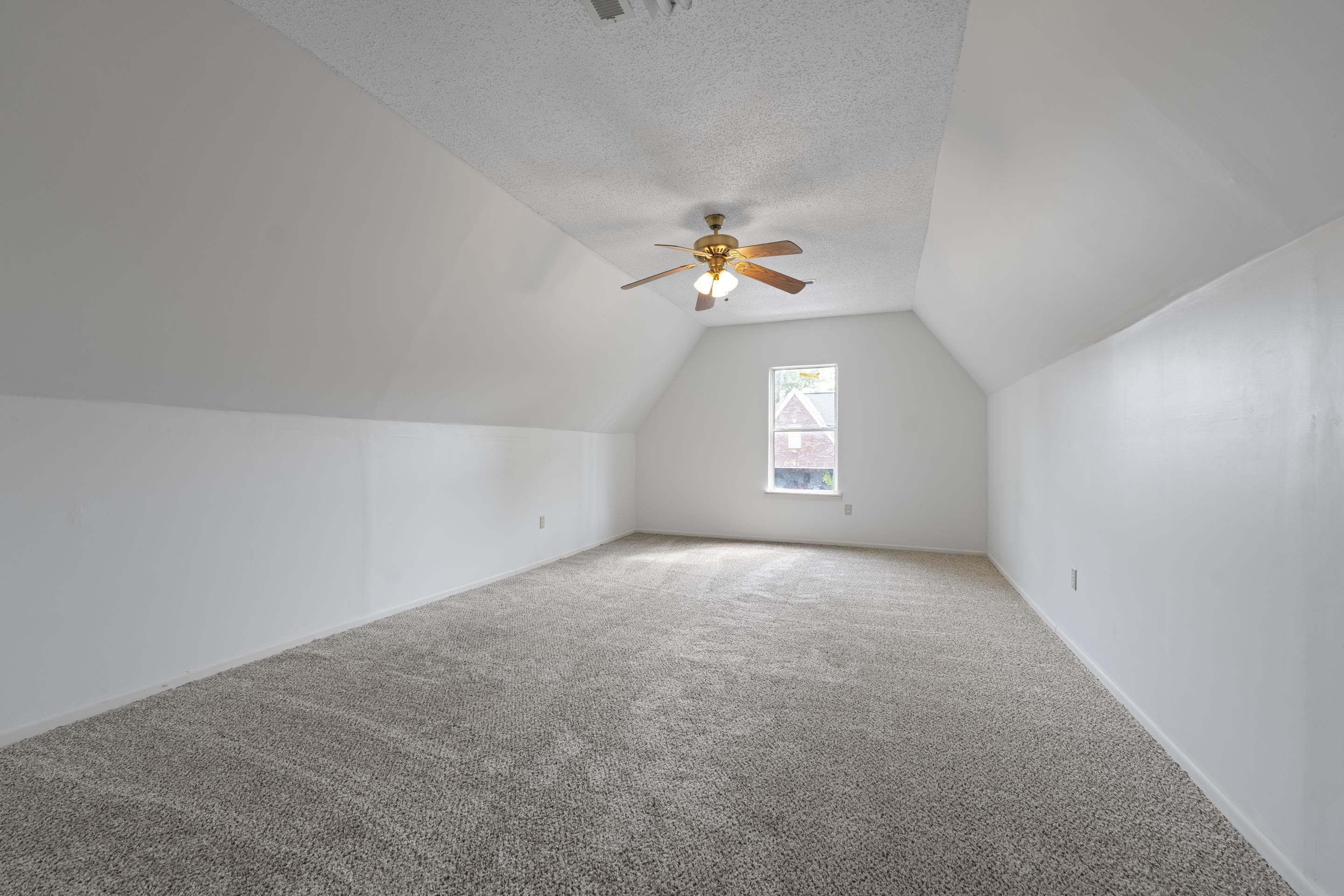 1104 Macon Hall Road Cordova, TN 38018 - Photo 26 of 34 Bonus room featuring a textured ceiling, ceiling fan, lofted ceiling, and carpet floors
