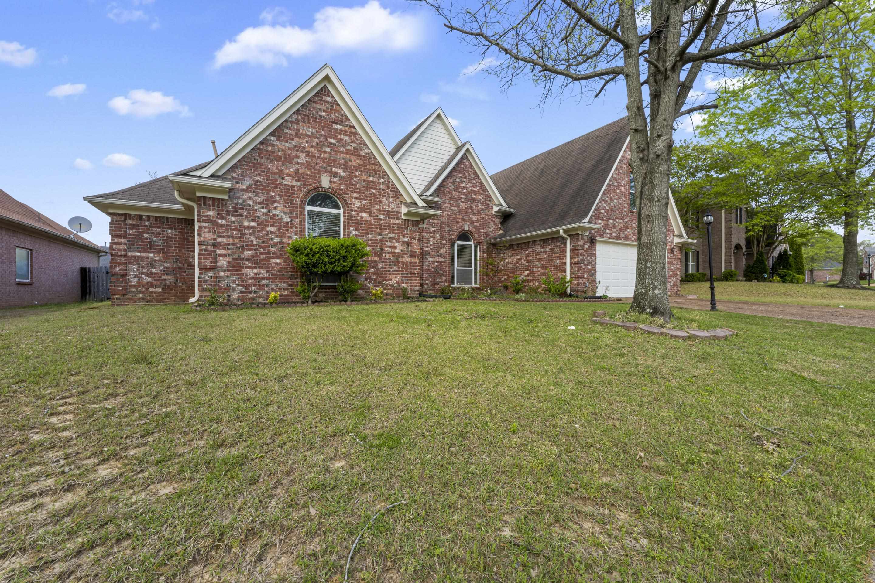 1104 Macon Hall Road Cordova, TN 38018 - Photo 33 of 34 Traditional home featuring a front yard, brick siding, a garage, and driveway