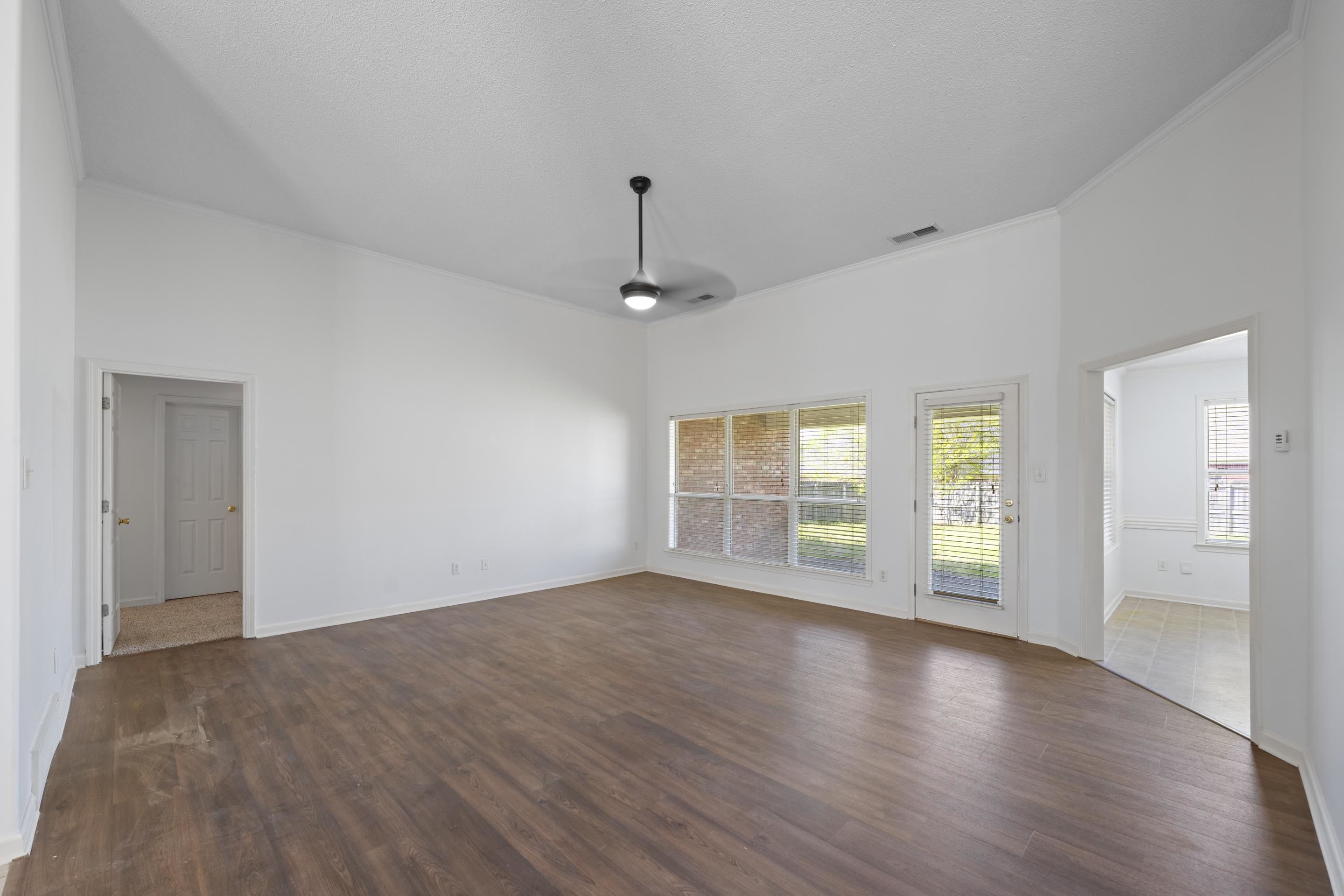 1104 Macon Hall Road Cordova, TN 38018 - Photo 5 of 34 Unfurnished living room with visible vents, crown molding, and dark wood finished floors