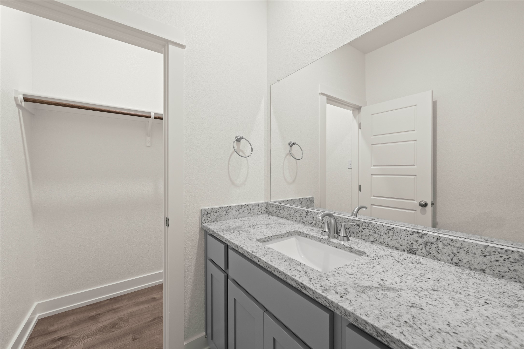 564 Gus Loop Georgetown, TX 78626 - Photo 24 of 32 a bathroom with a granite countertop sink and a mirror
