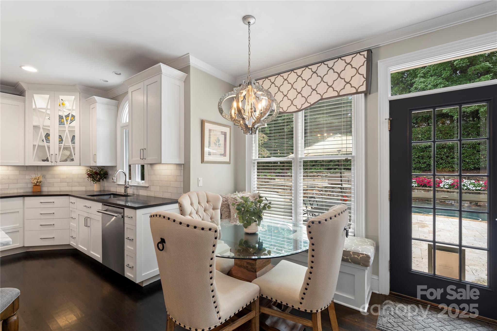 14654 Trading Path Way Charlotte, NC 28277 - Photo 18 of 48 a kitchen with stainless steel appliances granite countertop a stove a sink dishwasher and a dining table with wooden floor