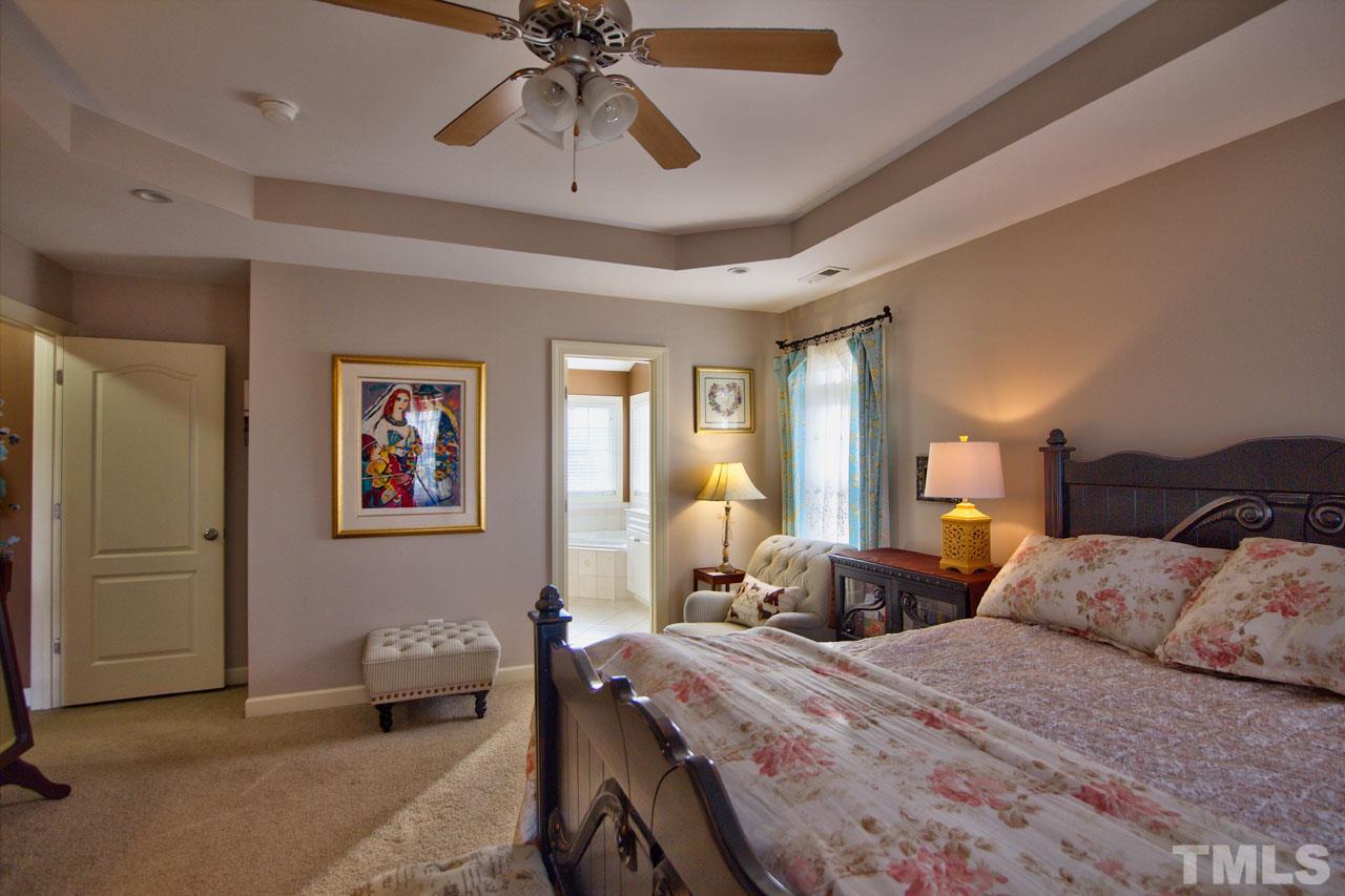 1021 Newburgh Circle Raleigh, NC 27603 - Photo 15 of 25 a bedroom with furniture and a chandelier