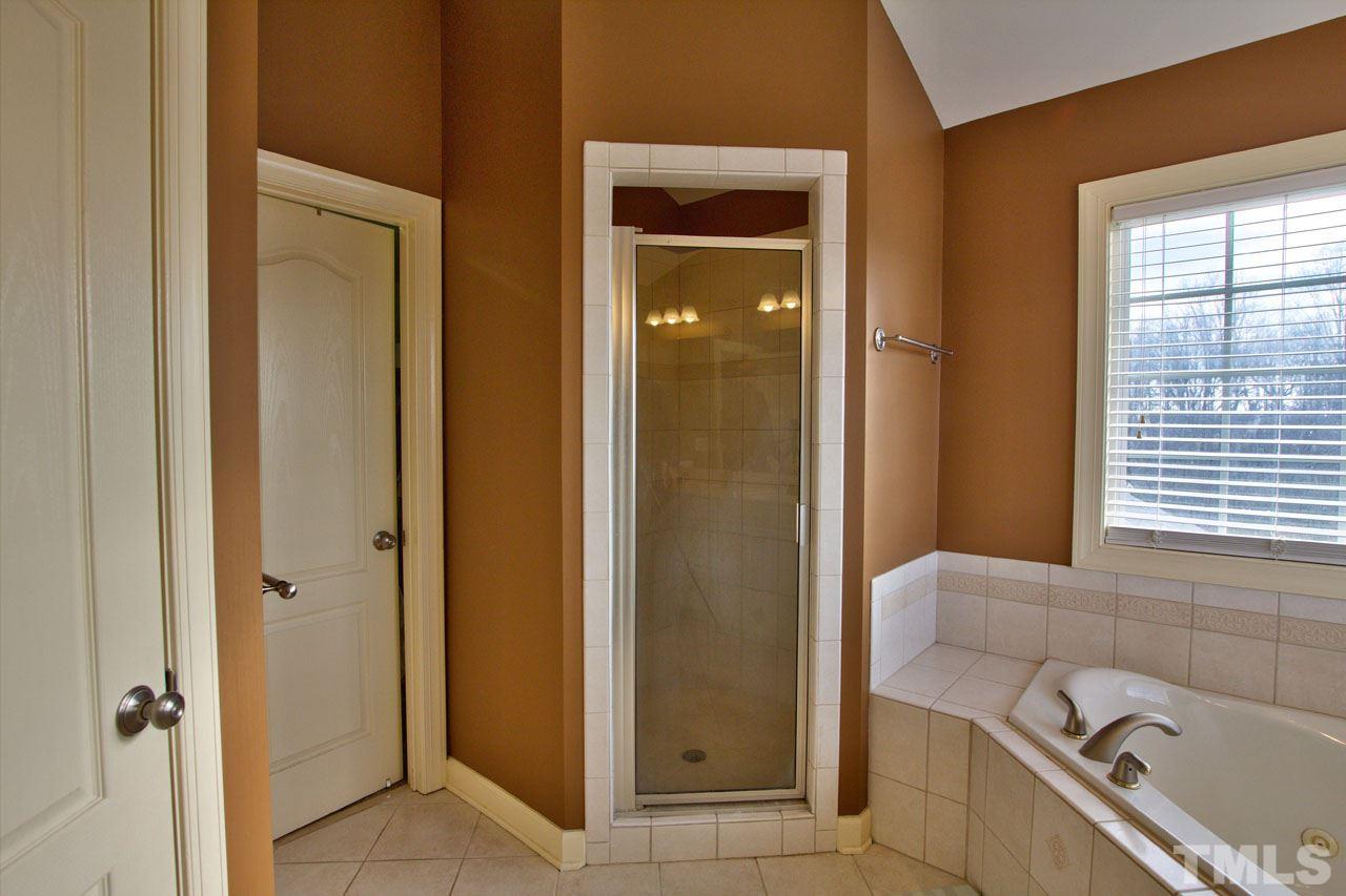 1021 Newburgh Circle Raleigh, NC 27603 - Photo 17 of 25 a bathroom with a tub and a sink