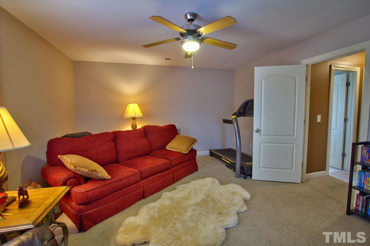 1021 Newburgh Circle Raleigh, NC 27603 - Photo 22 of 25 a living room with furniture and a ceiling fan