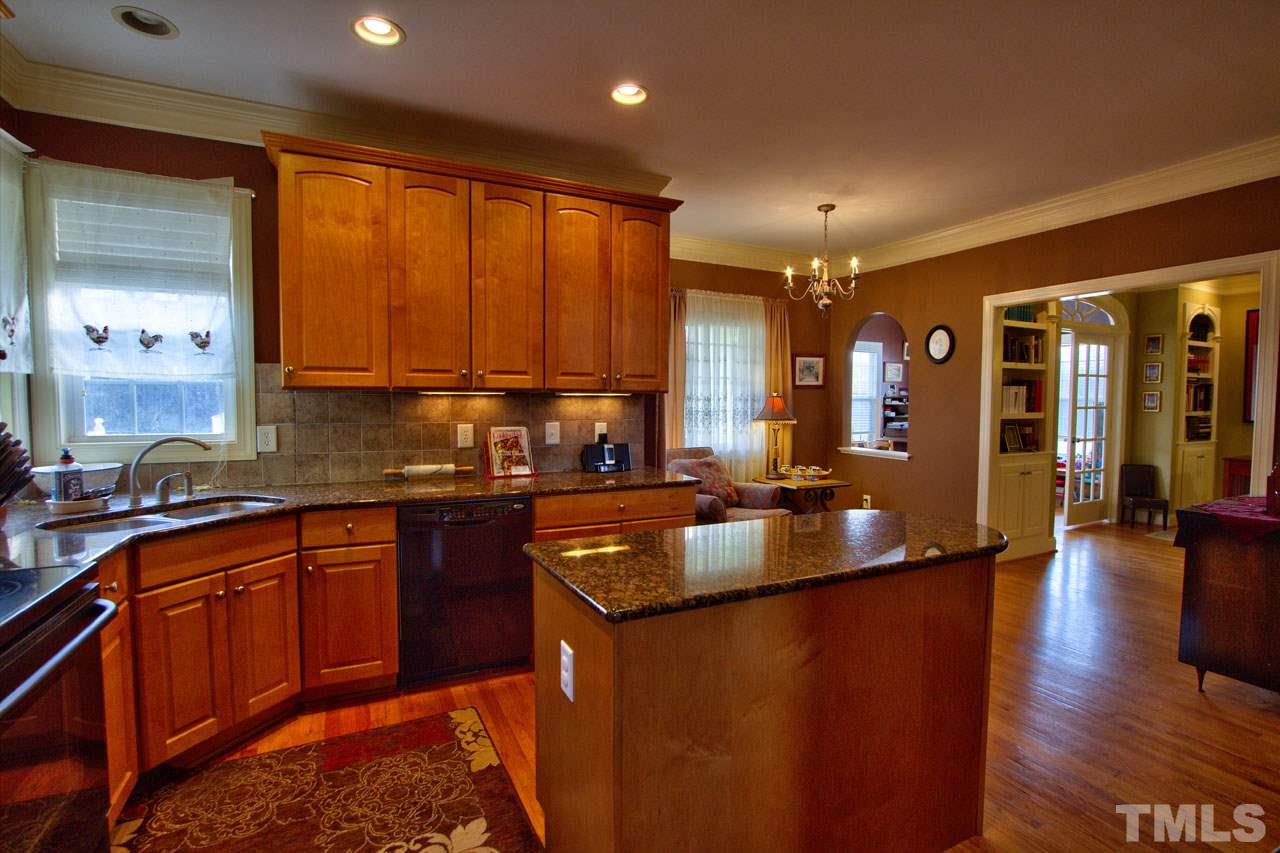 1021 Newburgh Circle Raleigh, NC 27603 - Photo 7 of 25 a kitchen with stainless steel appliances granite countertop sink stove top oven and cabinets