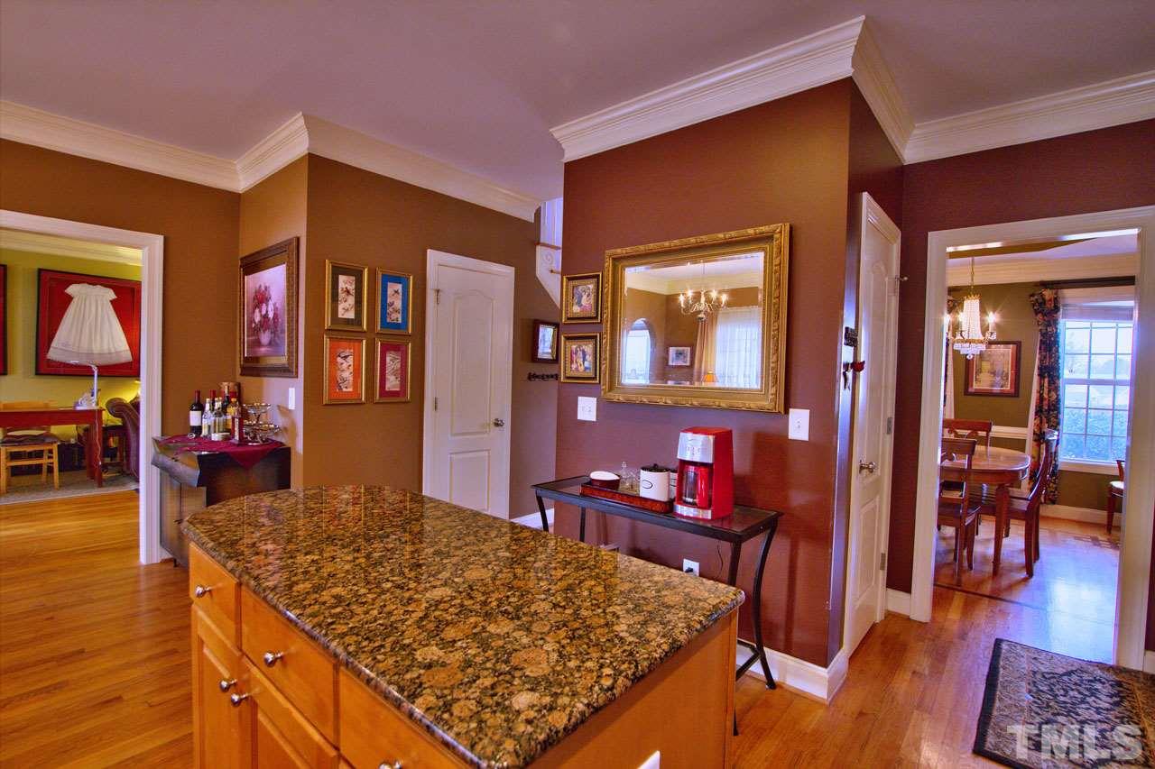 1021 Newburgh Circle Raleigh, NC 27603 - Photo 9 of 25 a living room with dining table and wooden floor