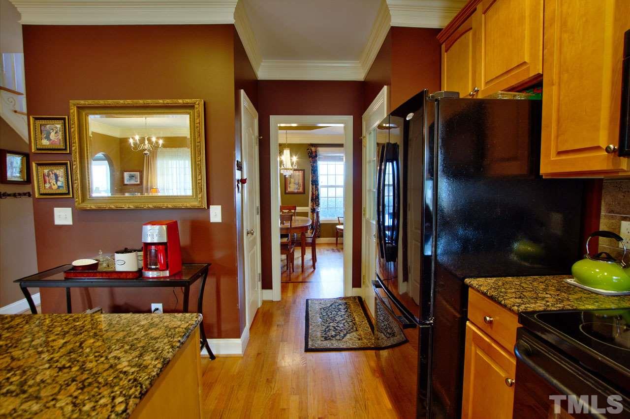 1021 Newburgh Circle Raleigh, NC 27603 - Photo 10 of 25 a view of a kitchen area with furniture and wooden floor