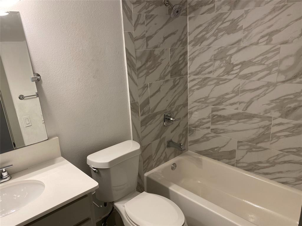 4633 Fairmount Street, Unit 110 Dallas, TX 75219 - Photo 11 of 13 a bathroom with a sink and toilet