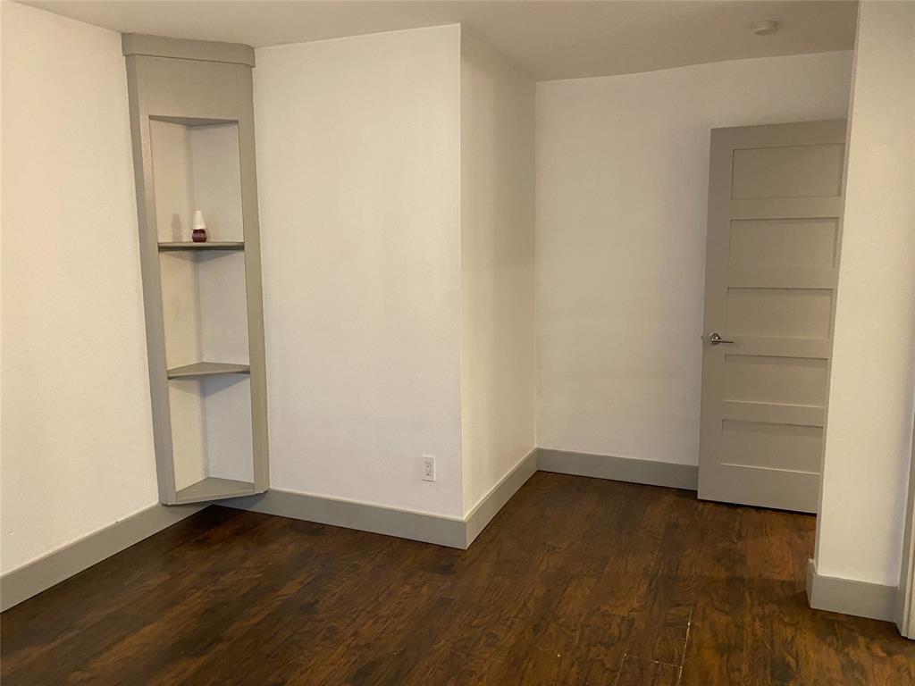 4633 Fairmount Street, Unit 110 Dallas, TX 75219 - Photo 4 of 13 an empty room with wooden floor