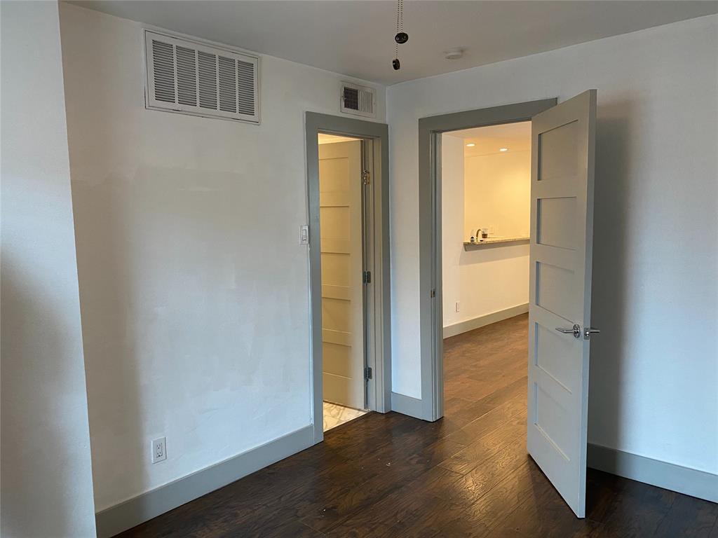 4633 Fairmount Street, Unit 110 Dallas, TX 75219 - Photo 6 of 13 an empty room with wooden floor and closet