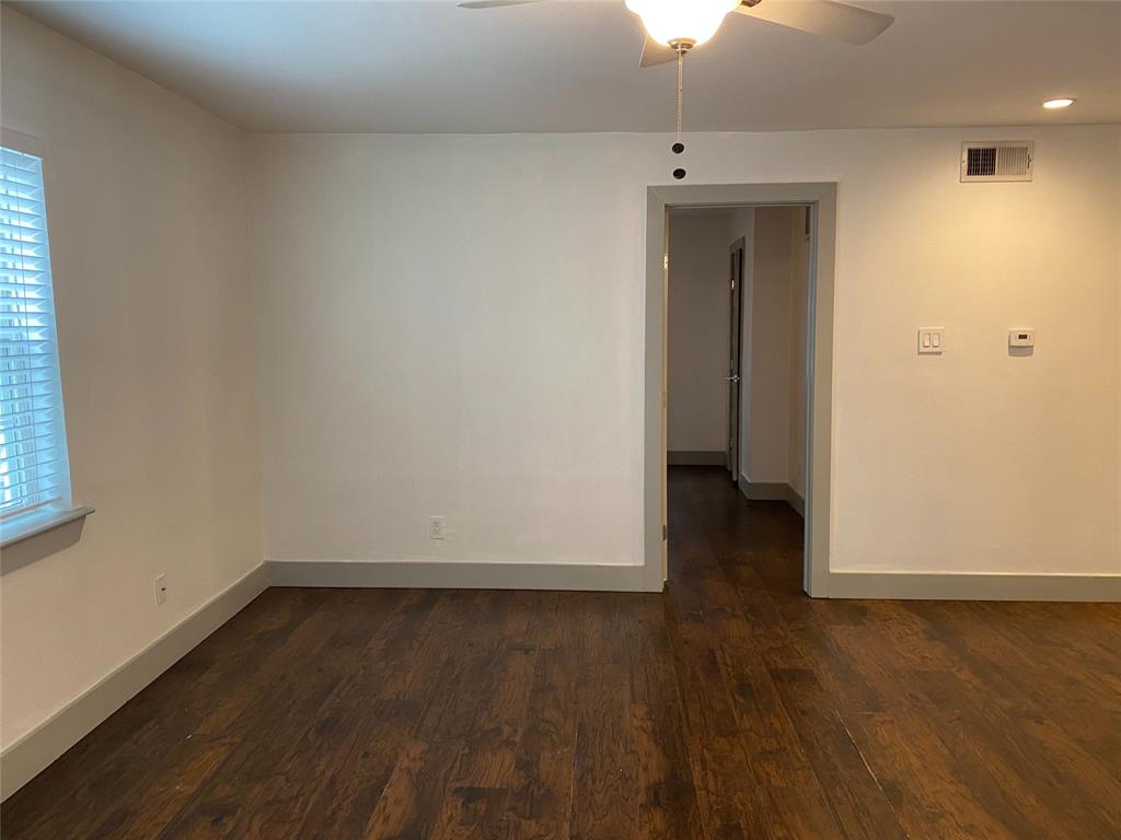 4633 Fairmount Street, Unit 110 Dallas, TX 75219 - Photo 7 of 13 an empty room with wooden floor and a window