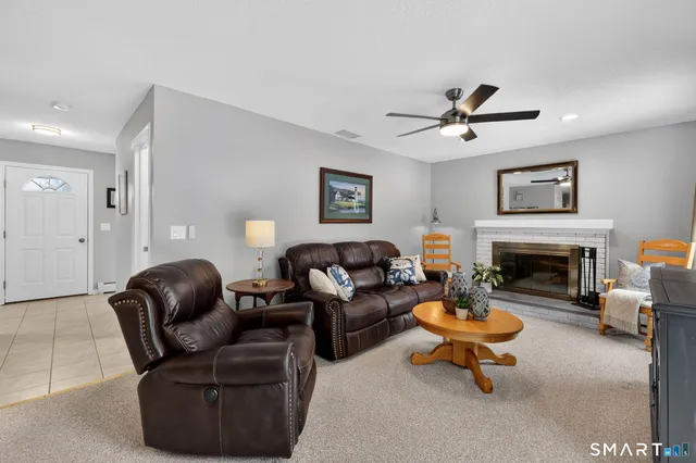 a living room with furniture two lamp and a fireplace