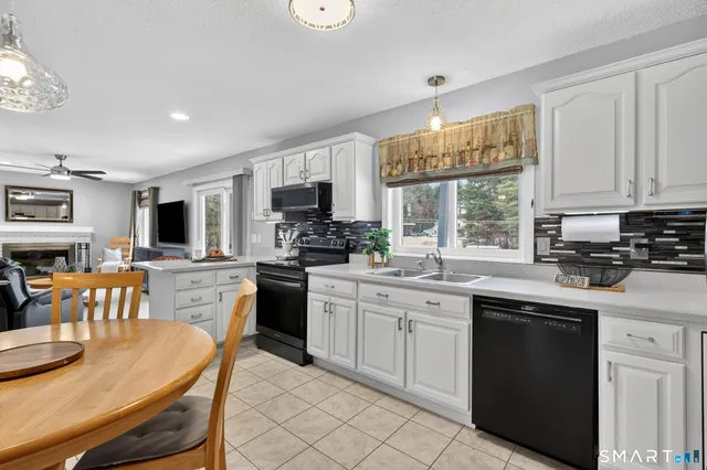 a kitchen with a sink stove and microwave