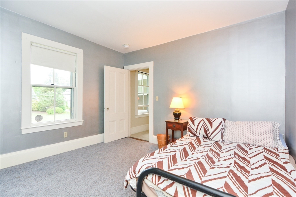 37 Pemberton Road Wayland, MA 01778 - Photo 26 of 34 a bedroom with a bed and wooden floor