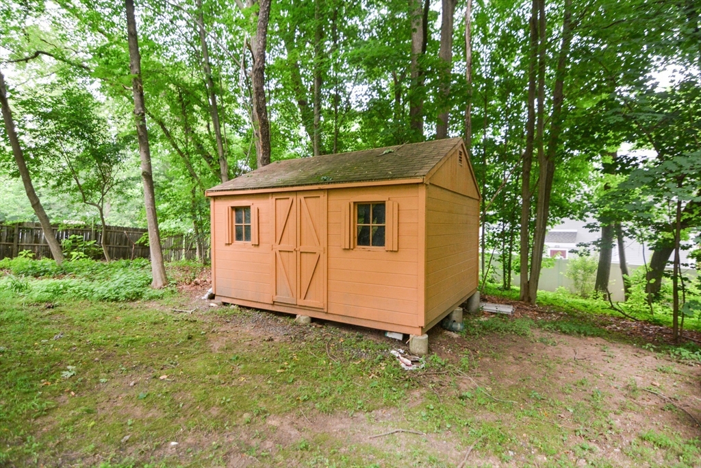 37 Pemberton Road Wayland, MA 01778 - Photo 33 of 34 a view of backyard with large tree and wooden fence