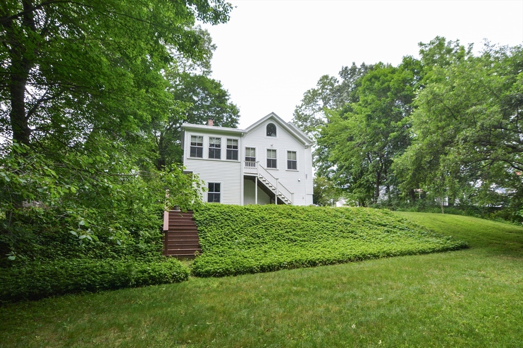 37 Pemberton Road Wayland, MA 01778 - Photo 34 of 34 a house with green field in front of it