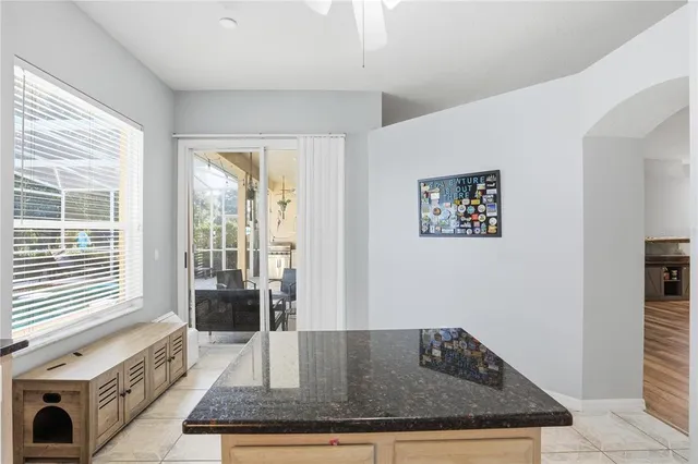 a large white room with a granite countertop sink