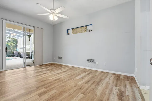 wooden floor in an empty room with a window