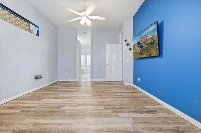 a view of room with window and ceiling fan