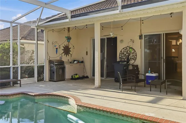 a swimming pool with table and chairs