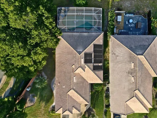 an aerial view of a house with a yard
